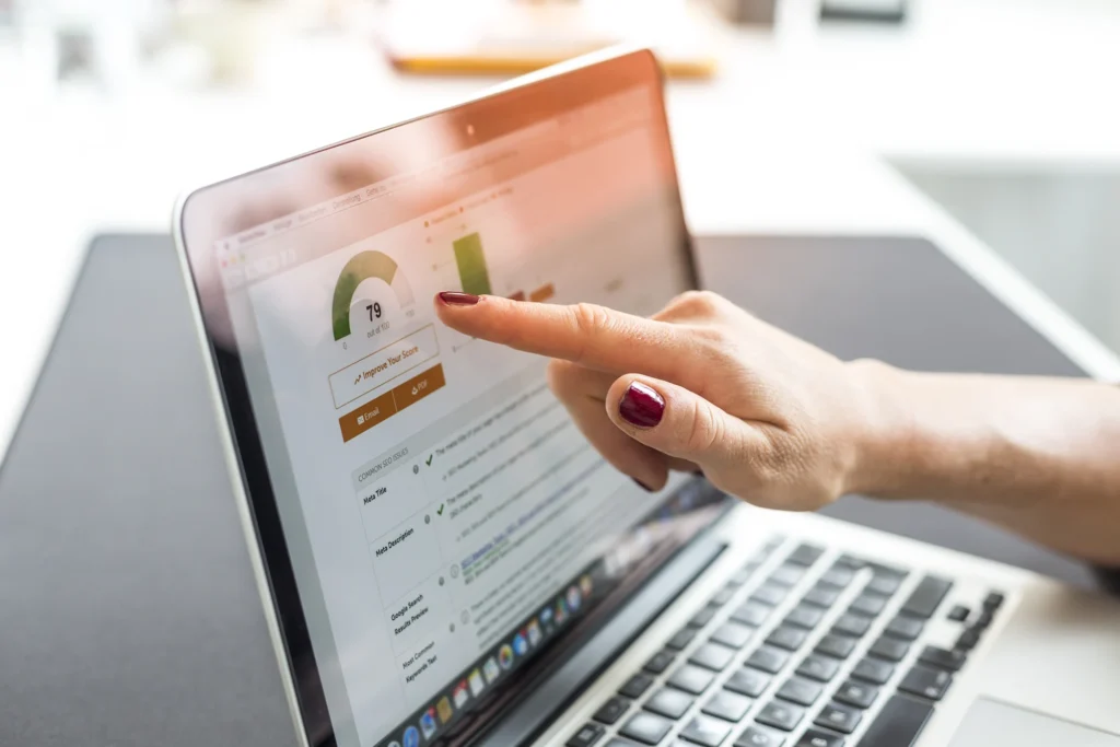 a woman pointing to seo data on a laptop screen