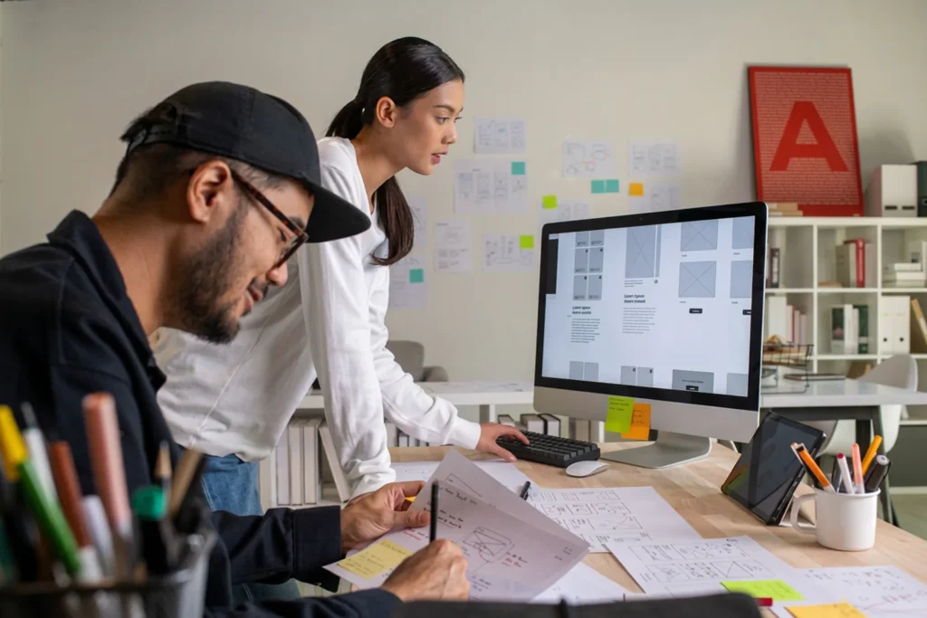 2 people working on a computer on landing page design